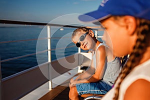 Kids relaxing on a boat ride. Summer vacation