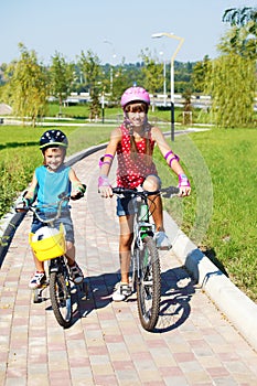 Kids riding bikes in park