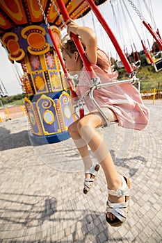 Kids riding on colorful amusement carousel
