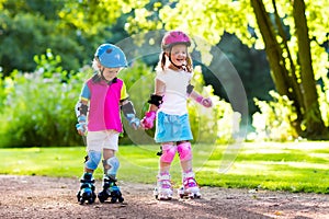 Kids roller skating in summer park