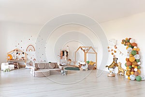 Kids room interior in contemporary, Scandinavian style. Wooden bed, sofa and toys. Cozy room for child.