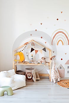 Kids room interior in contemporary, Scandinavian style. Wooden bed, sofa and toys. Cozy room for child.