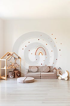 Kids room interior in contemporary, Scandinavian style. Wooden bed, sofa and toys. Cozy room for child.