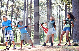Kids, rope and tug of war for play adventure, challenge and strength game in woods with summer camping. Children