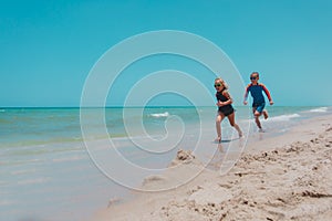 kids run, boy and girl have fun on tropical beach