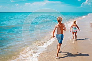 kids run, boy and girl have fun on tropical beach