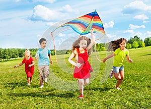 Kids run with kite photo