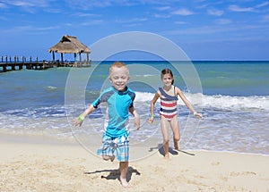 Kids running on the beach together