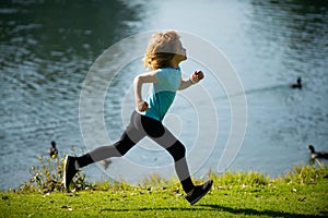 Kids running outdoors. Child runner jogger running in the nature. Morning jogging. Active healthy kids lifestyle.