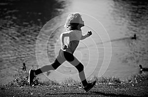 Kids running outdoors. Child runner jogger running in the nature. Morning jogging. Active healthy kids lifestyle.