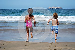 Kids running towards the sea