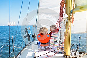 Kids sail on yacht in sea. Child sailing on boat.