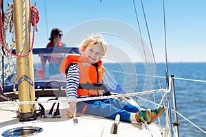 Kids sail on yacht in sea. Child sailing on boat