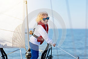 Kids sail on yacht in sea. Child sailing on boat