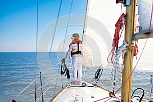 Kids sail on yacht in sea. Child sailing on boat