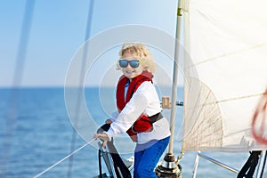 Kids sail on yacht in sea. Child sailing on boat.