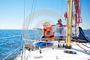 Kids sail on yacht in sea. Child sailing on boat. photo