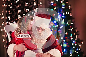 Kids and Santa at fire place on Christmas eve