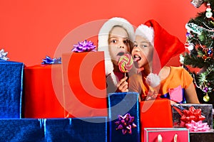 Kids in Santa hats with gift boxes, copy space.