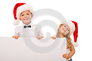 Kids with santa hats and white banner for text