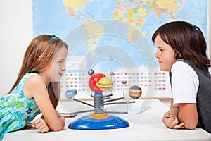 Kids with a scale model planetary system in science class