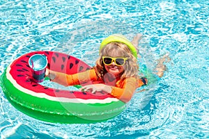 Kids on sea beach. Cute funny child boy relaxing with toy swimming ring in a swim pool having fun during summer vacation