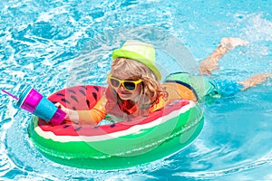 Kids on sea beach. Happy child playing in swimming pool. Summer kids vacation.