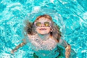 Kids on sea beach. Happy kid playing in swimming pool on summer day. Child water vacation. Children play in tropical