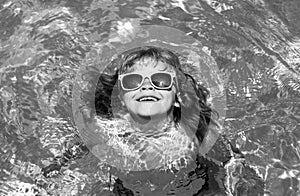 Kids on sea beach. Happy kid playing in swimming pool on summer day. Child water vacation. Children play in tropical