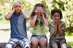 Kids, see and hear or speak no evil, forest bench and sitting down for playing, face, covering ears or mouth. Children