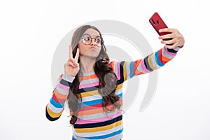 Kids selfie. Funny face. Teenager child girl holding smartphone. Hipster girl with cell phone. Kid hold mobile phone