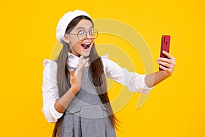 Kids selfie. Portrait of cute teenage girl using mobile phone, chatting on web, typing sms message. Mobile app for