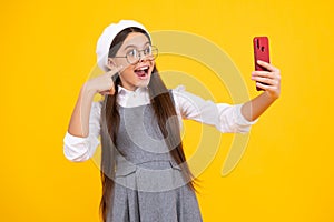 Kids selfie. Teenage girl with smart phone. Portrait of teen child using mobile phone, cell web app. Excited teenager