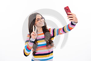 Kids selfie. Teenager child girl holding smartphone. Hipster girl with cell phone. Kid hold mobile phone texting in