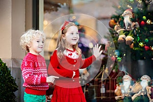 Kids shopping for Christmas presents. Children buy Xmas decorati