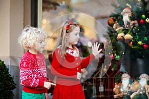 Kids shopping for Christmas presents. Children buy Xmas decorati