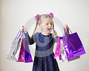 Kids shopping. Smiling little girl with shopping bags