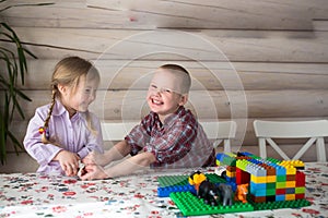 Kids siblings brother and sister playing constructor, share toys