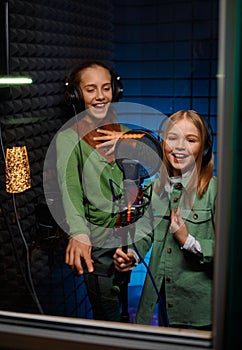 Kids singing in record studio