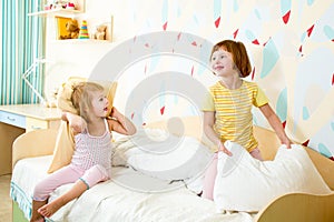 Kids sisters play on bed