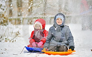 Kids sit on sled