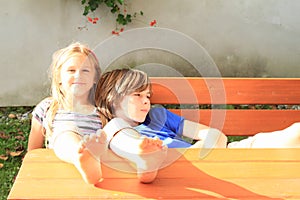 Kids sitting behind wooden table