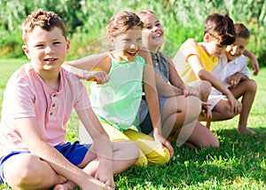 Kids sitting on grass