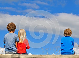 Kids sitting over the sky