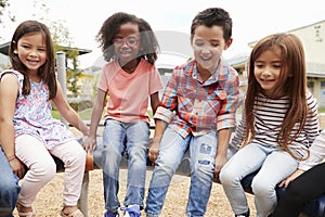 Kids sitting on a spinning carousel in their schoolyard