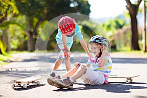 Kids with skate board. Skateboard fall and injury