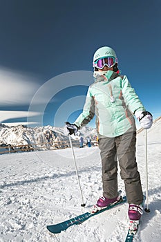 Kids ski lesson in alpine school. Little skier posing
