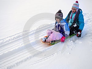 Kids Sledding Down Snow Hill on Sled Fast Speed