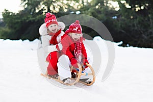 Kids on sleigh. Children sled. Winter snow fun.