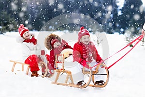 Kids on sleigh. Children sled. Winter snow fun.